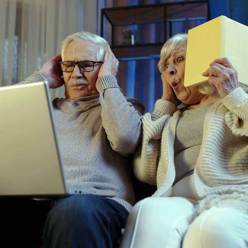 Happy senior couple researching reverse mortgage in North California